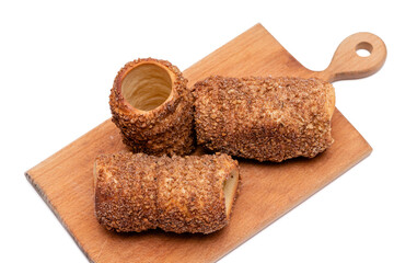 trdelnik on a wooden board on a white background
