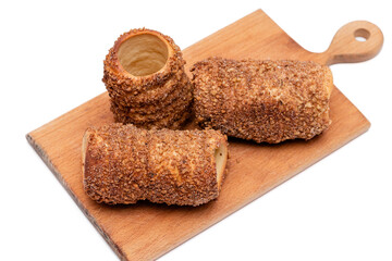 trdelnik on a wooden board on a white background