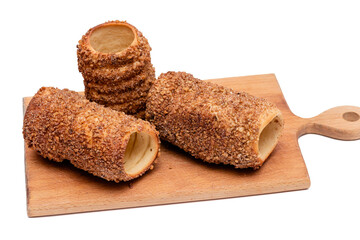 trdelnik on a wooden board on a white background