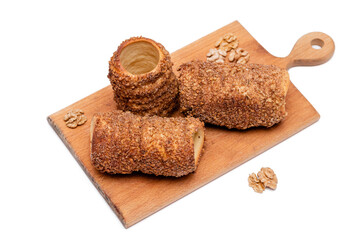 trdelnik on a wooden board on a white background