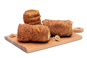 trdelnik on a wooden board on a white background