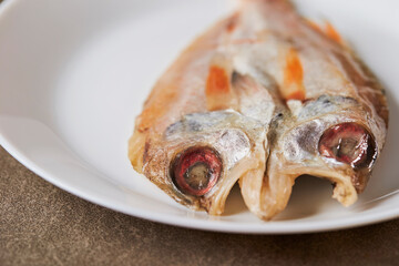dried red fish on a plate