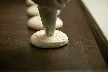 Making macarons, meringue close-up in the oven