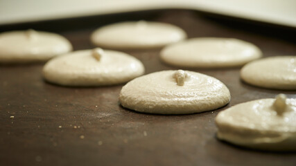 Making macarons, meringue close-up in the oven