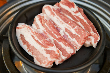 Raw pork belly on the grill 