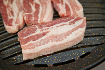 Raw pork belly on the grill 