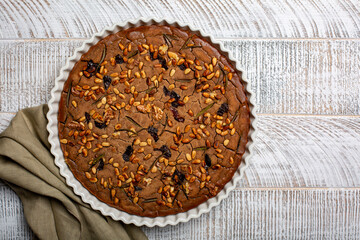 Castagnaccio cake. Plain chestnut flour vegan cake,  made with water, olive oil, pine nuts,...