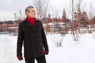 An elderly, slender man walks in the winter park Zaryadye. Moscow. Hiking, rest