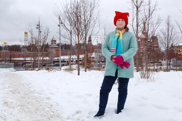 A girl in bright and funny clothes walks in the winter park Zaryadye. Moscow. Hiking, rest