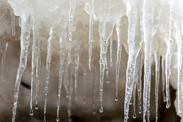 photograph with frozen ice icicles of different shapes and appearance by the sea, winter by the sea