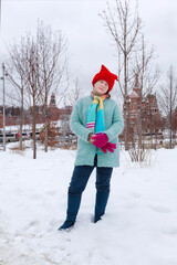 A girl in bright and funny clothes walks in the winter park Zaryadye. Moscow. Hiking, rest