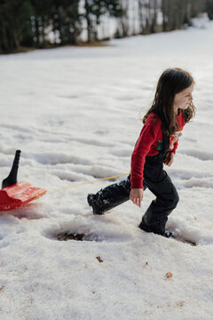Mädchen mit Zipfelbob im Schnee