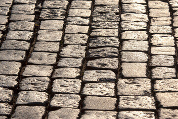 pavement close up in the sunlight. background texture of street stone