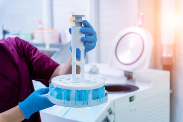 Laboratory assistant works with microwave hybrid tissue processor at the modern laboratory.