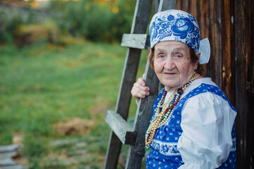 An elderly woman in Slavic national dress. Black and white photograph.