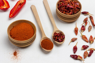 Ground pepper in wooden bowl and spoon.