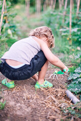 child playing an growing with the earth on a summer afternoon