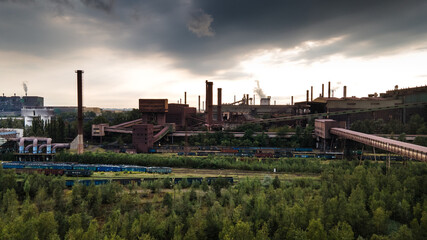 Fototapeta premium factory with smoking chimneys dark clouds