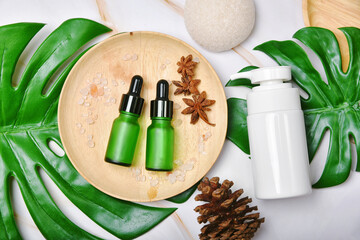 Natural skincare beauty product with spices oil, Cosmetic pump bottle containers packaging with green nature leaves, Blank label for organic spa branding mock-up,Herbal healthy skin care.