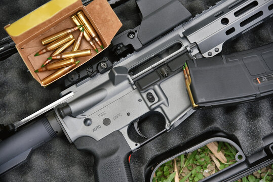 Close-up of a M4A1 (AR-15 model) and 5.56 bullets weapons and military equipment for army, Assault rifle gun on a black case box.