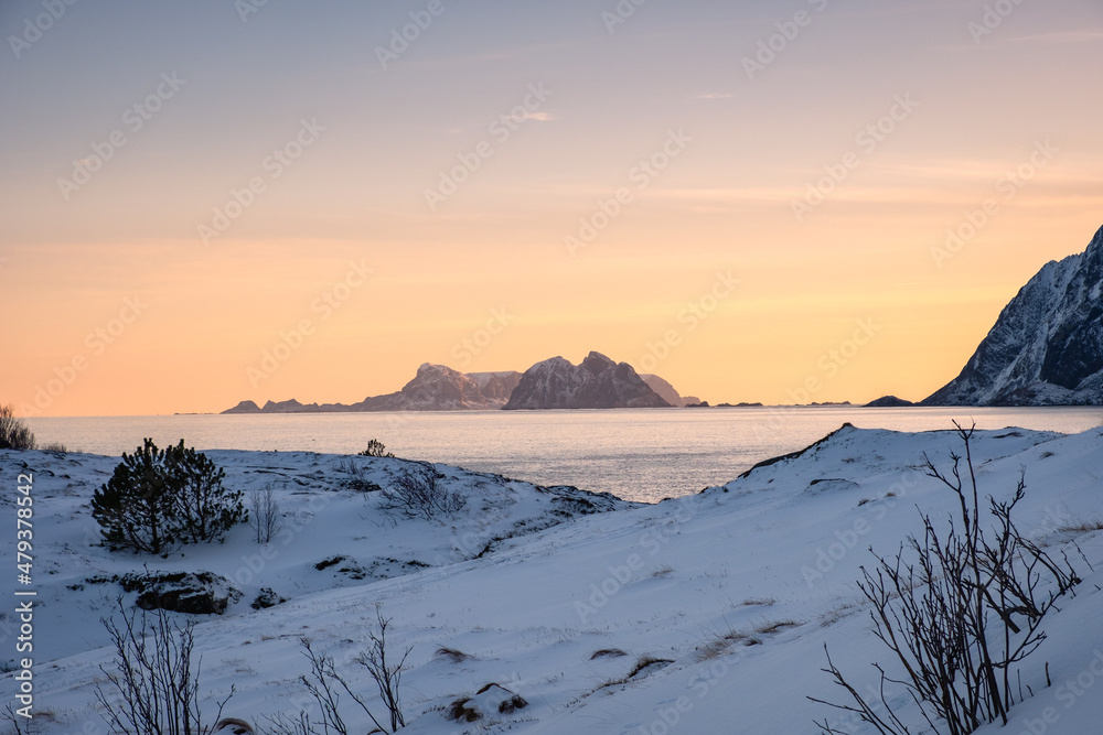 Wall mural scenery of mountain with snow pile on coastline in the evening on winter at lofoten islands