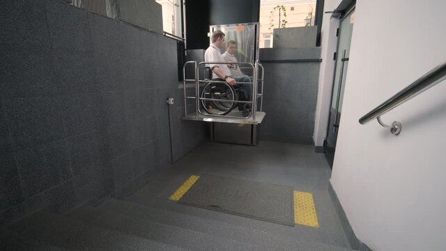 Special elevator for the person with a physical disabilities. A man in a wheelchair uses a special elevator