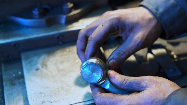 Turner&rsquo;s hands adjusting metal piece to a detail. Turner checking the compatibility of grinded details. Close up.