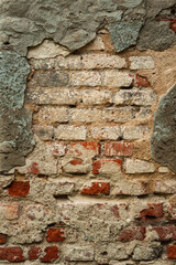 old textured brick wall with peeling cement plaster. creative vertical background