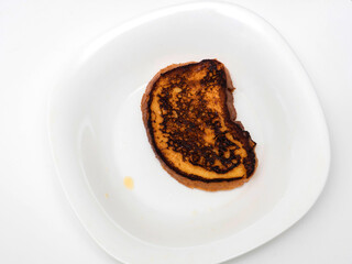 Burnt toast bread on plate, isolated on white background