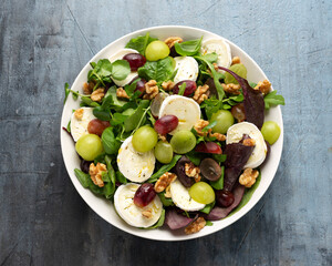 Italian salad with goat cheese, grapes and walnuts. Healthy Food