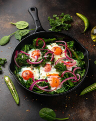 Green shakshuka with golden yolk eggs, kale, spinach and tender broccoli served with pickled onions and chilli flakes