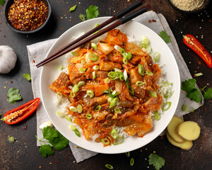 Korean Stir Fried pork belly kimchi with rice and spring onion. Asian food style