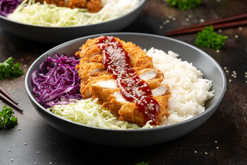 Crispy Katsu chicken with sauce, rice and cabbage.