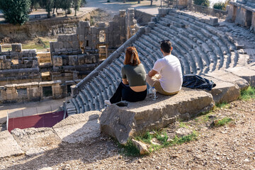 tourists rest on the ruins of the ancient stadium of Myra in Demre, Turkey