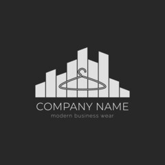 Vector isolated black and white clothing logo with hangers and city skyscrapers outlines.