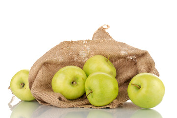 Several sweet green apples with a jute bag, close-up, isolated on white.
