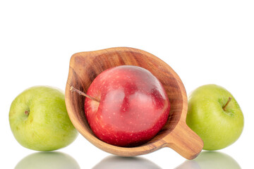 Two sweet green and red apples with a wooden cup, close-up, isolated on white.