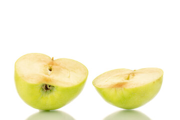 Two halves of a sweet green apple, close-up, isolated on white.