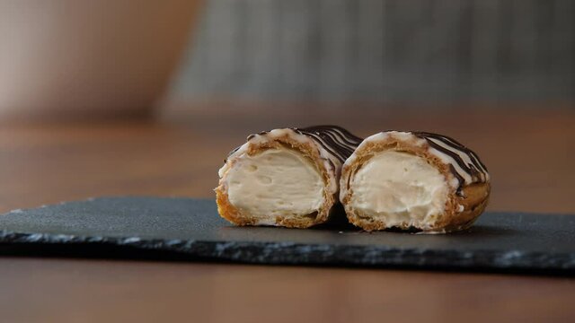 Close-up of a halved eclair with creamy filling