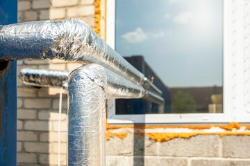 Heat insulated pipeline. Thermal insulation of hot water pipes with foil and cotton wool....