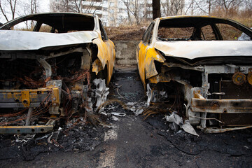 broken and burnt cars in the parking lot, accident or intentional vandalism