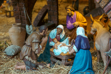 Fototapeta na wymiar Ceramic figurines representing the birth of jesus at the nativity scene in the crib portal