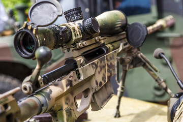 Modern powerful sniper rifle with a telescopic sight mounted on a bipod.Elements of the sniper rifle with tactical body .