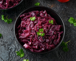 Braised Red Cabbage with apples and redcurrant in black bowl