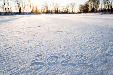 2022 inscription on the snow. The numbers of the year are written in the snow. Date two thousand...