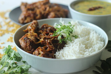 Kerala style dry chicken roast and lentil curry prepared with fenugreek leaves served with basmati rice. A healthy combination meal called rice with chicken and methi dal