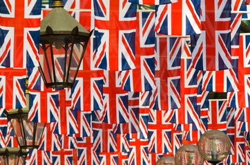 A large number of Union Jack flags hanging down among light fixtures