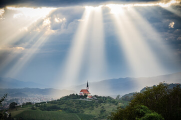 Fototapeta Sun rays shining down on a Church obraz