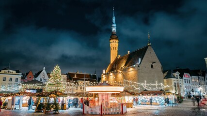 Tallinn, Estonia. Time-lapse Of Traditional Christmas Market And Carousel In Town Hall Square. Christmas Tree And Trading Houses. Famous Landmark And UNESCO World Heritage