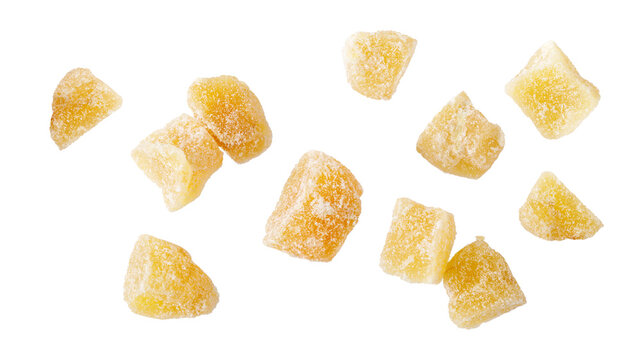 Candied ginger root pieces with sugar flying isolated on white background.